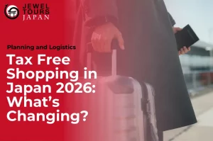 Tax free shopping in Japan 2026 airport refund system update with traveler holding suitcase at departure terminal